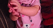 Davina is registered to the contest to win money with this photo: baby, infant, child, pink_onesie, clapping_hands, couch, indoor, smiling, blue_eyes, cute, soft_skin, seated, plush, cozy, warm_lighting, face, person, happy, toddler, young_child