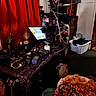 Sam joined the competition — help win amazing prizes! cat, animal, pet, indoor, room, cluttered_room, red_curtain, television, screen, laundry_basket, clothing, dresser, guitar, musical_instrument, table, plant, artwork, decor, blanket, home