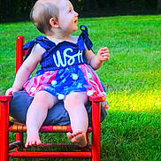 Oaklynn joined the competition — help win amazing prizes! baby, child, dress, red_chair, grass, outdoor, smile, barefoot, sitting, greenery, cute, summer, portrait, happy, nature, one_person, infant, sunlight, colorful, playful