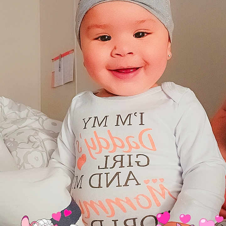 Mikaela joined the competition — help win amazing prizes! accessories, applique, baby, beanie, bonnet, cap, clothing, couch, face, furniture, happy, hat, head, pattern, person, photography, portrait, smile, t_shirt, toy