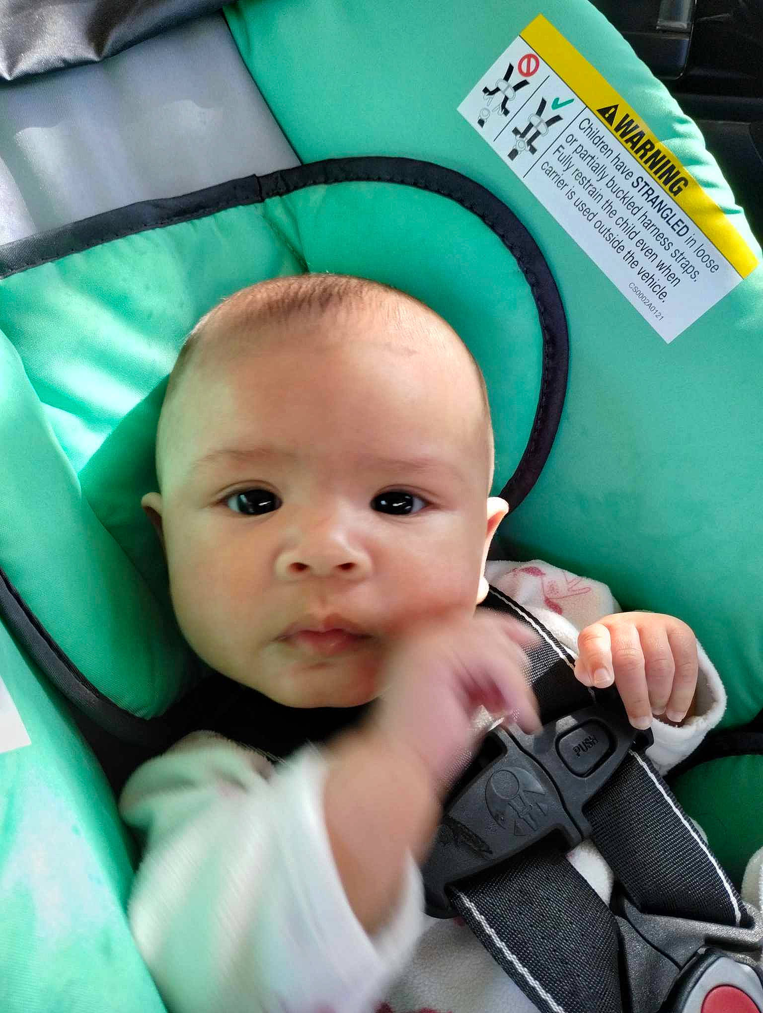 Mikaela is registered to the contest to win money with this photo: auto_part, baby, baby_carriage, baby_in_car_seat, baby_products, baby_safety, baby_toddler_clothing, car_seat, cheek, child, comfort, eyelash, happy, nail, person, product, seat_belt, service, sitting, steering_wheel