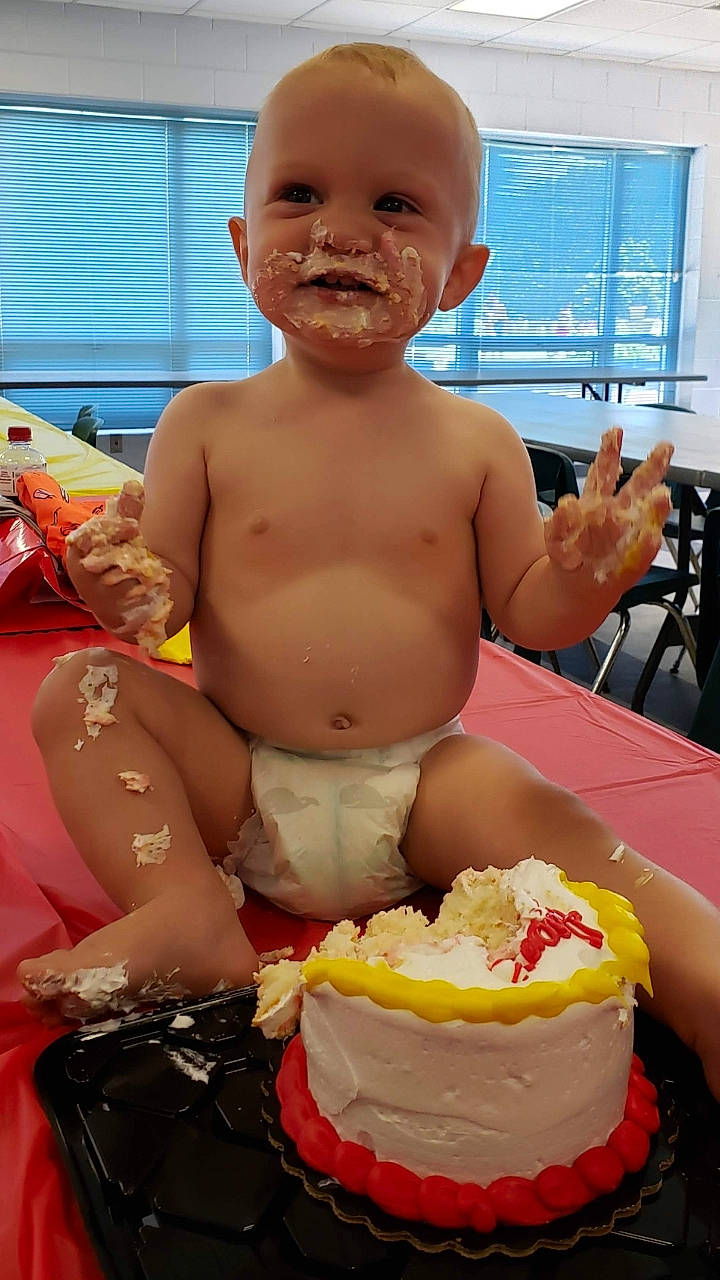 Jensen is registered to the contest to win money with this photo: baby, birthday, birthday_cake, cake, child, cream, cuisine, dessert, food, person, toddler
