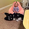 Aubrey is registered to the contest to win money with this photo: baby, child, toddler, sitting, portrait, smiling, pajamas, blanket, strawberry_chair, plush, indoor, home, carpet, playpen, furniture, table, book, cozy, family, cute