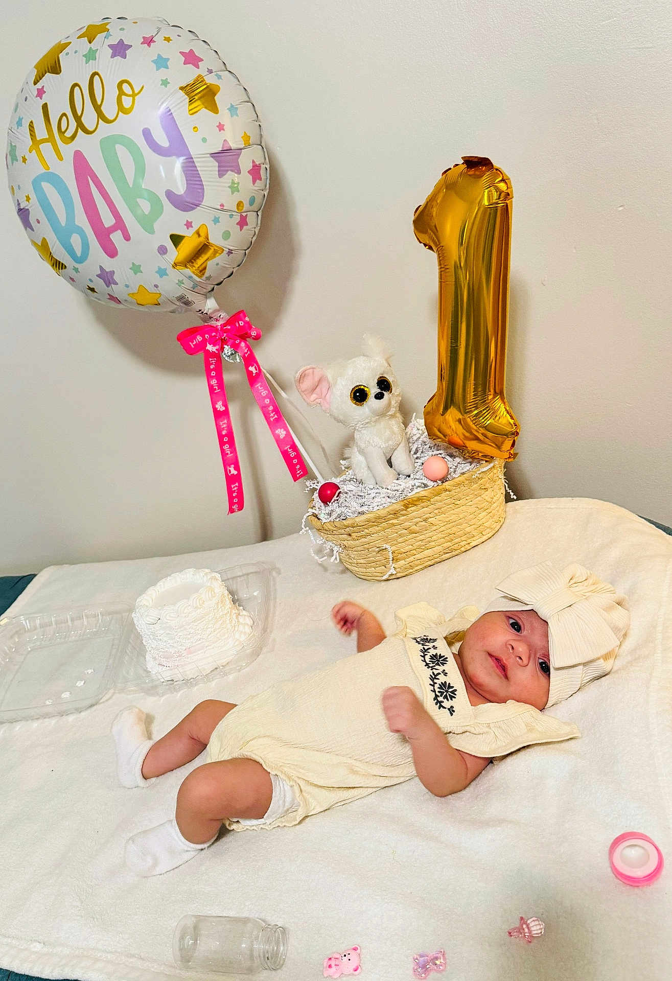 Nasya is registered to the contest to win money with this photo: baby, balloon, birthday, cake, celebration, cloth, cream, decor, face, headband, infant, laying, number_one, plush_toy, ribbon, soft_blanket, toy, white, yellow, pink