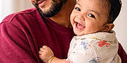 Ayansh is registered to the contest to win money with this photo: baby, father, parent, smile, laughing, hug, portrait, indoor, cozy, maroon_sweater, beard, short_hair, infant, holding, affectionate, happy, closeup, neutral_background, natural_light, casual_clothing