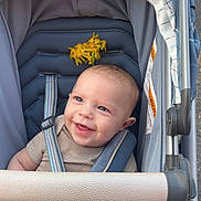 Colby joined the competition — help win amazing prizes! baby, stroller, smiling, child, blue, flowers, safety_harness, outdoor, cute, infant, happy, person, seat, canopy, head, hand, daylight, fabric, metal, portrait