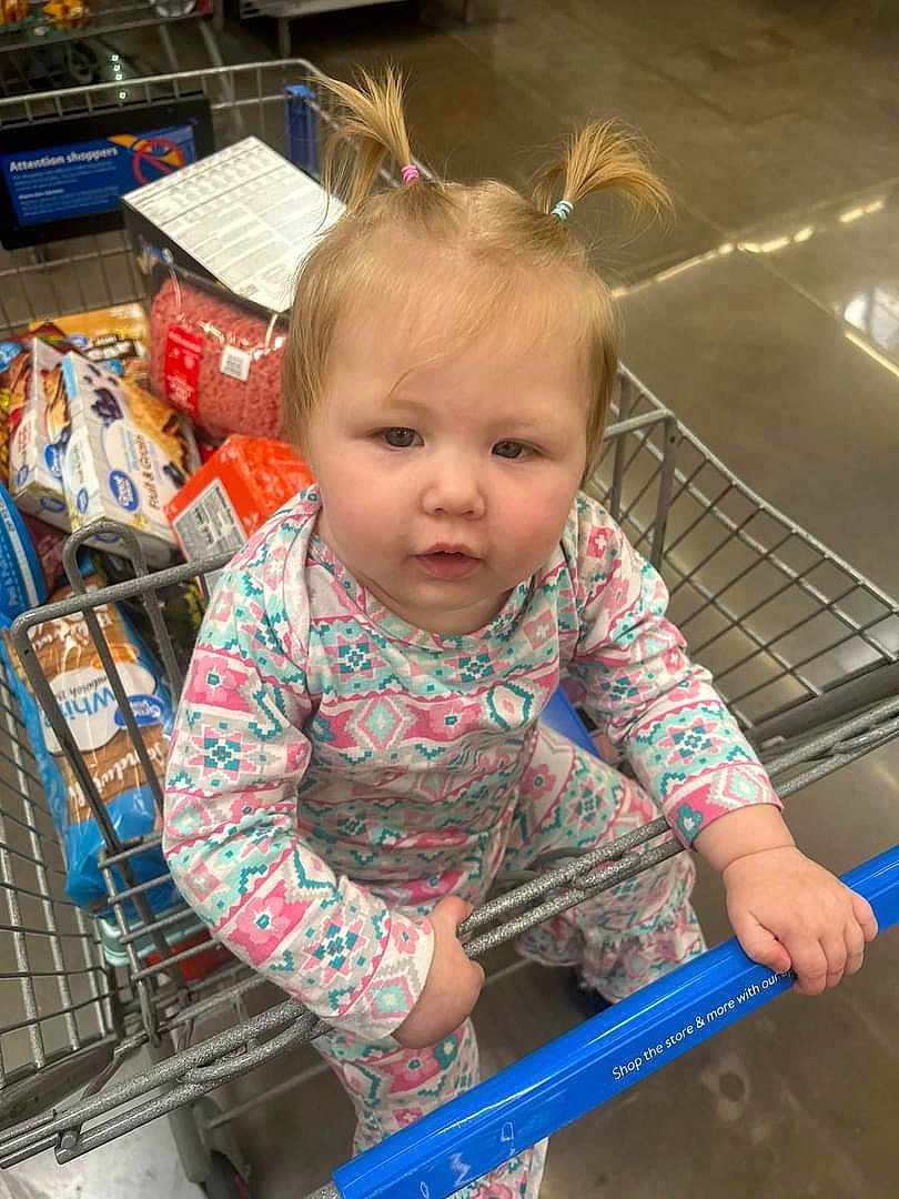 Isabella is registered to the contest to win money with this photo: baby, babycrawling, crawling, cricket, cricketbat, face, hair, head, person, pushing, shopping, shoppingcart, sport