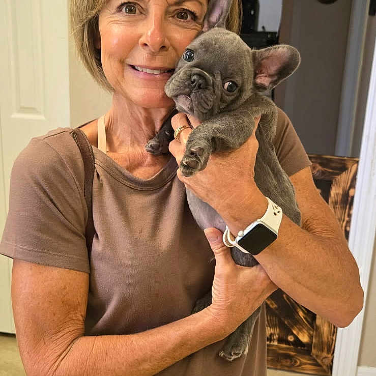 Diesel joined the competition — help win amazing prizes! blue_jeans, brown_shirt, casual_clothing, cute, dog, doorway, floor_tiles, french_bulldog, happy, holding, home, indoor, light_skin, pet, portrait, puppy, short_hair, smiling, watch, woman