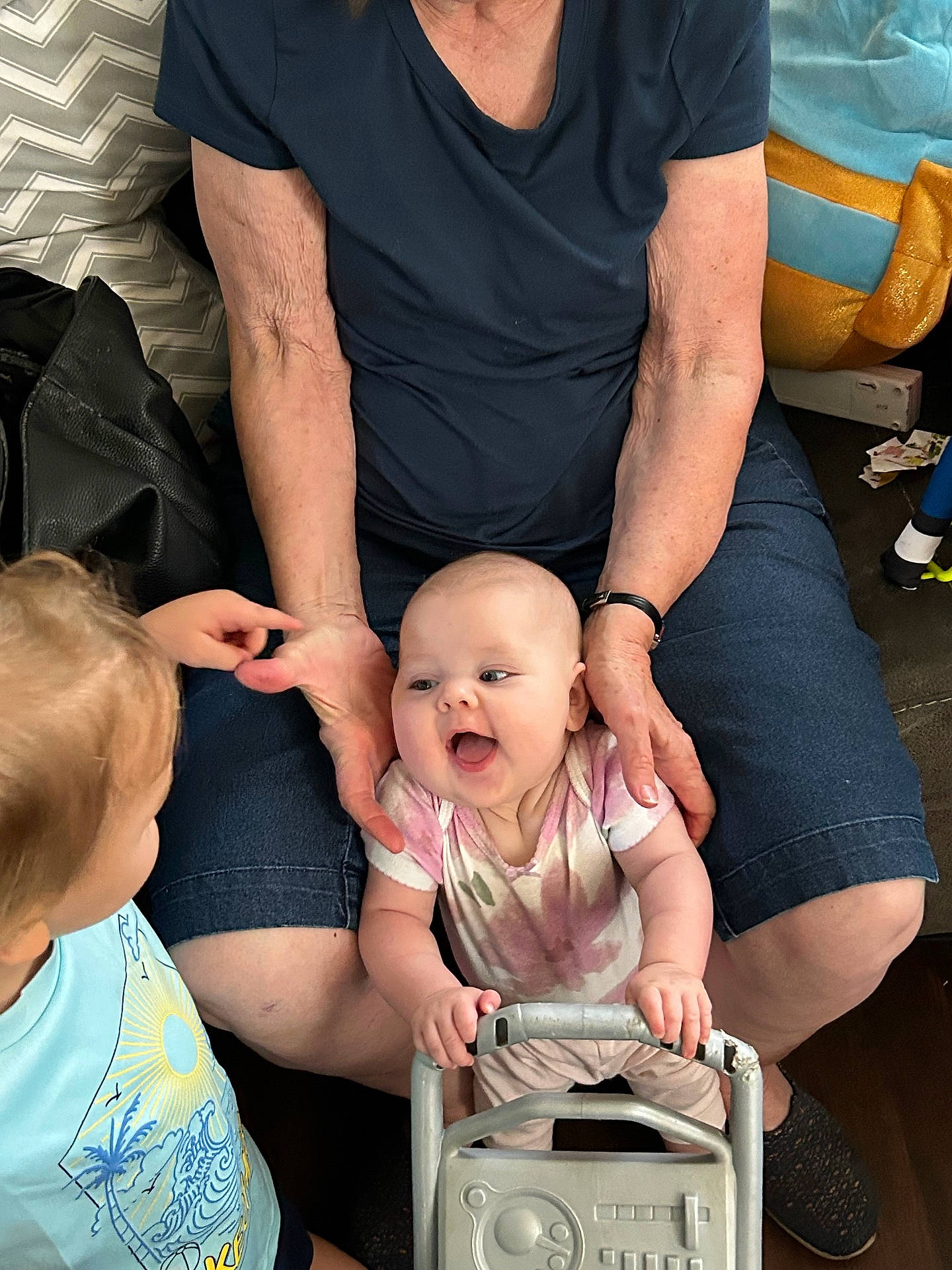 Eleanor is registered to the contest to win money with this photo: accessories, baby, babylaughing, chair, clothing, face, furniture, happy, head, jewelry, laughing, necklace, pants, people, person, photography, portrait, stroller, t_shirt, yawning