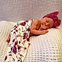 newborn, baby, sleeping, blanket, floral, headband, pink_bow, cozy, white_blanket, texture, peaceful, resting, infant, soft, portrait, cute, child, indoors, wrapped, relaxed