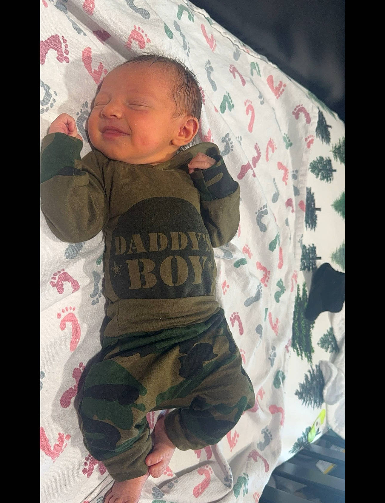 Braxton is registered to the contest to win money with this photo: baby, baby_products, baby_safety, baby_toddler_clothing, cheek, child, comfort, cool, linens, mouth, outerwear, pattern, person, pink, room, sitting, skin, sleeve, t_shirt, textile