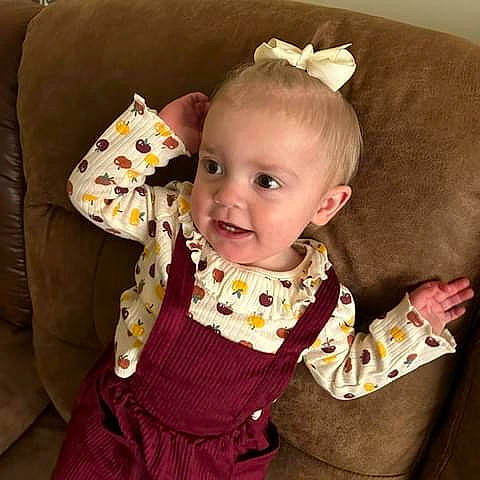 Michaela joined the competition — help win amazing prizes! baby, baby_products, baby_toddler_clothing, cheek, child, collar, comfort, couch, face, fashion_accessory, happy, head, linens, pattern, person, sitting, skin, sleeve, smile, textile