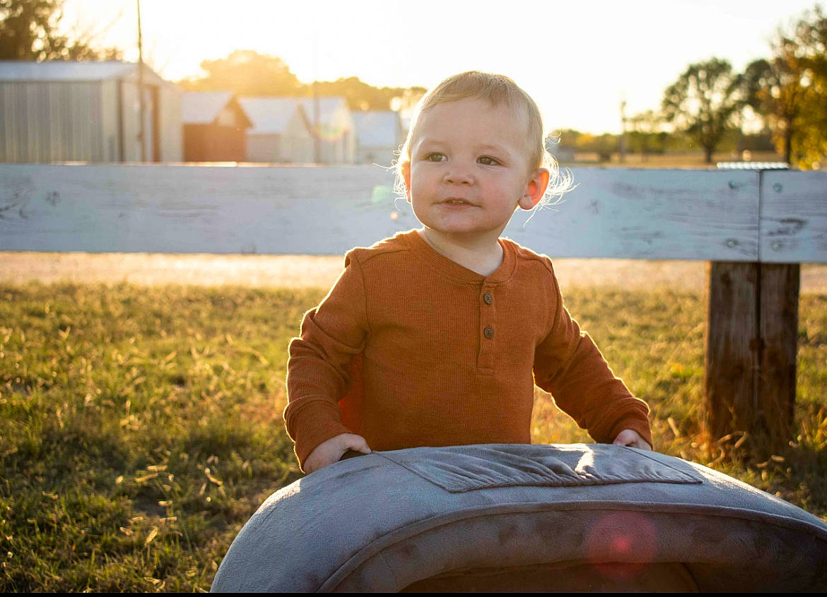 Layken is registered to the contest to win money with this photo: baby, eye, face, flash_photography, fun, grass, grassland, happy, head, landscape, lawn, leisure, people_in_nature, person, plant, sky, smile, summer, sunlight, toddler
