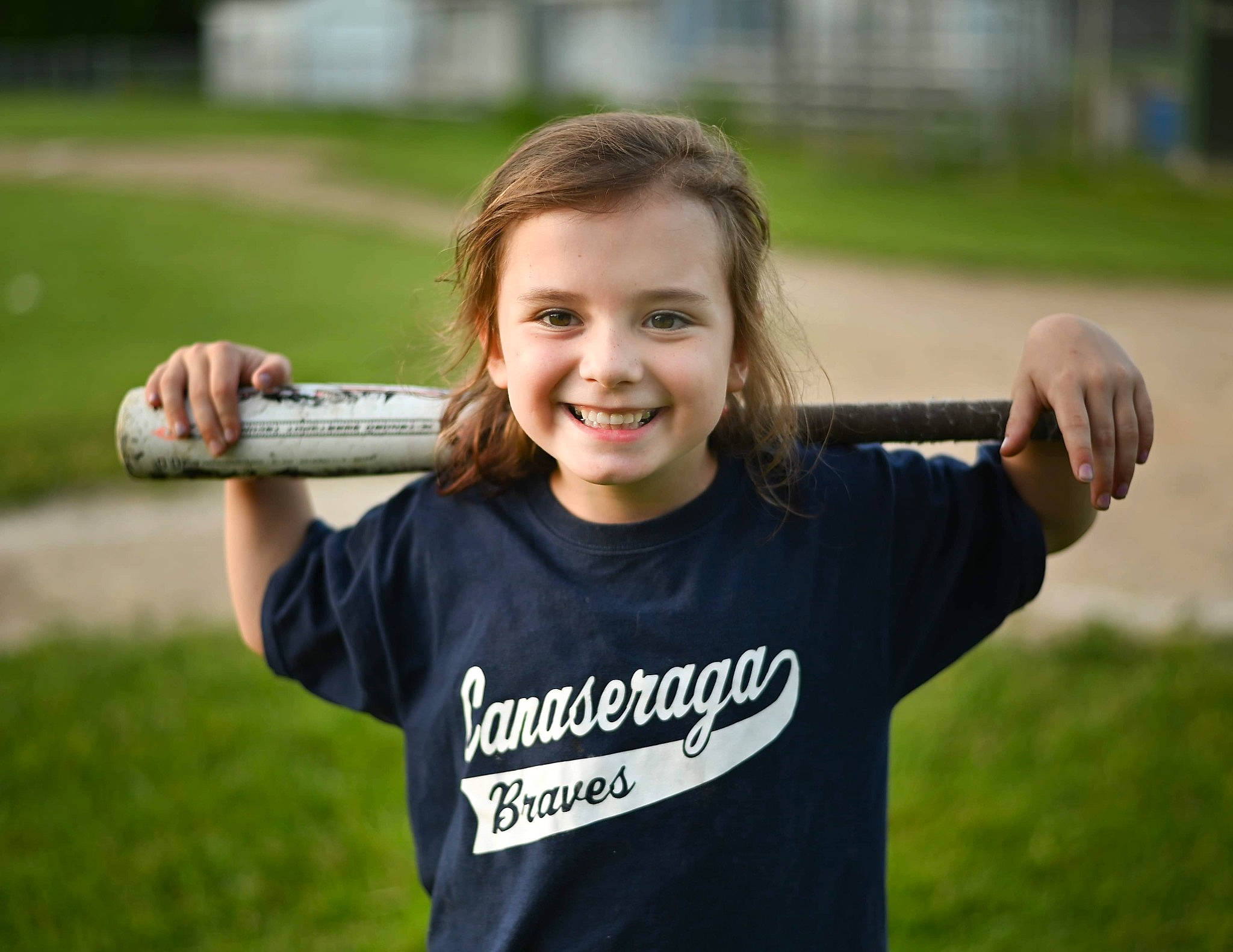 Kathleen is registered to the contest to win money with this photo: arm, child, competition_event, finger, fun, gesture, grass, grass_family, grassland, happy, joy, leisure, people_in_nature, person, player, recreation, sleeve, smile, t_shirt, thumb