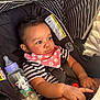 baby, child, car_seat, bottle, bib, striped_clothing, hand, face, infant, seatbelt, cute, indoors, curious, young_child, black_hair, patterned_fabric, sitting, closeup, safety, adorable