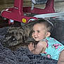 Stella joined the competition — help win amazing prizes! baby, dog, blanket, indoor, baby_walker, smiling, child, pet, cuddling, floor, cozy, onesie, floral, cute, animal, toddler, resting, happy, playtime, domestic