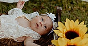 Lakelynn joined the competition — help win amazing prizes! baby, baby_girl, blanket, child, cute, face, flower, flower_decoration, grass, head, headband, infant, lace_clothing, lying_down, nature, newborn, outdoor, portrait, soft_light, sunflower