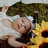 Lakelynn joined the competition — help win amazing prizes! baby, infant, lace_clothing, headband, flower, sunflower, outdoor, grass, blanket, portrait, cute, child, nature, soft_light, newborn, head, face, lying_down, flower_decoration, baby_girl