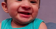 Tobias is registered to the contest to win money with this photo: baby, background, cheerful, child, closeup, cozy, cute, expression, face, happy, head, indoors, person, portrait, seated, skin, sleeveless, smiling, turquoise_shirt, young_child