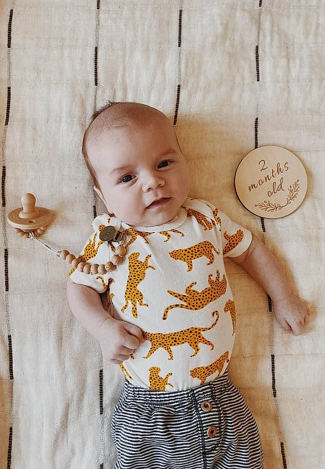 Elijah is registered to the contest to win money with this photo: arm, baby, baby_toddler_clothing, cheek, child, day_dress, dress, face, facial_expression, hairstyle, happy, head, people, person, skin, sleeve, standing, textile, toddler, white