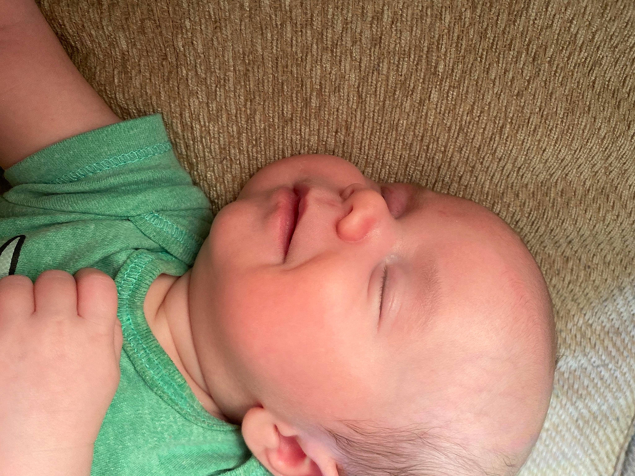 Elijah is registered to the contest to win money with this photo: arm, baby, cheek, chin, clothing, comfort, eye, eyebrow, forehead, hair, hand, head, human_body, joint, lip, mouth, muscle, neck, nose, person