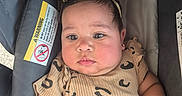 Tiffany Hernandez joined the competition — help win amazing prizes! adorable, baby, car_seat, cheeks, child, close_up, clothing, earring, eyes, face, headband, indoors, infant, looking_at_camera, patterned_outfit, photograph, portrait, safety_label, sitting, stroller