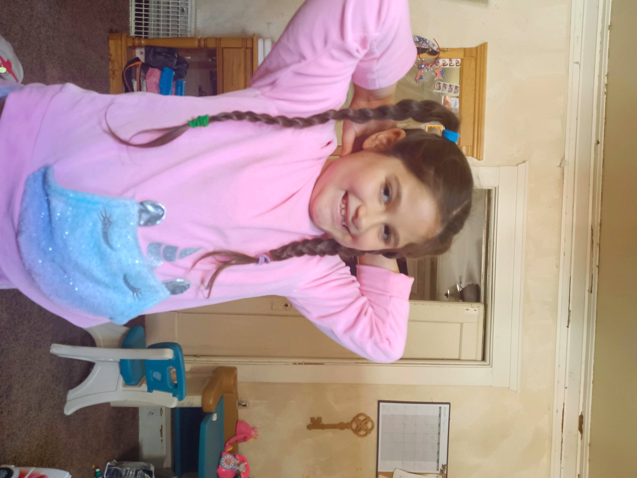 Melanie is registered to the contest to win money with this photo: child, door, fun, happy, joy, magenta, person, pink, room, smile, textile, toddler, wood