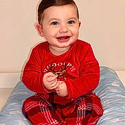 Arman participe au concours pour gagner de l'argent avec cette photo : baby, infant, child, smile, red_pajamas, plaid, reindeer, sitting, pillow, blue, indoors, wall, hands, teeth, portrait, cute, hair, eyes, chubby_cheeks, holiday