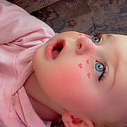 Luna joined the competition — help win amazing prizes! child, face, blue_eyes, pink_hoodie, heart_shapes, curious_expression, close_up, couch, person, indoor, casual_clothing, young_child, skin, head, ear, hair, sitting, comfort, background, portrait