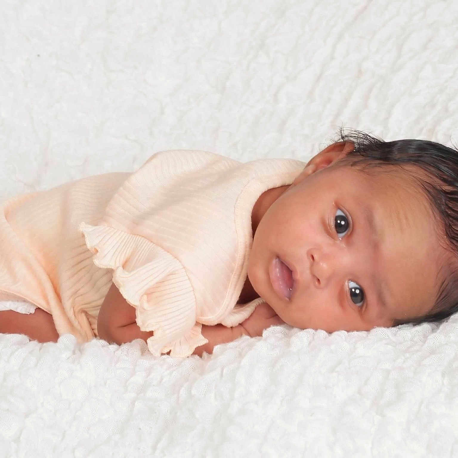 Dalilah is registered to the contest to win money with this photo: baby, blanket, bodypart, bonnet, clothing, face, finger, hand, happy, hat, head, newborn, person, photography, portrait, smile, towel