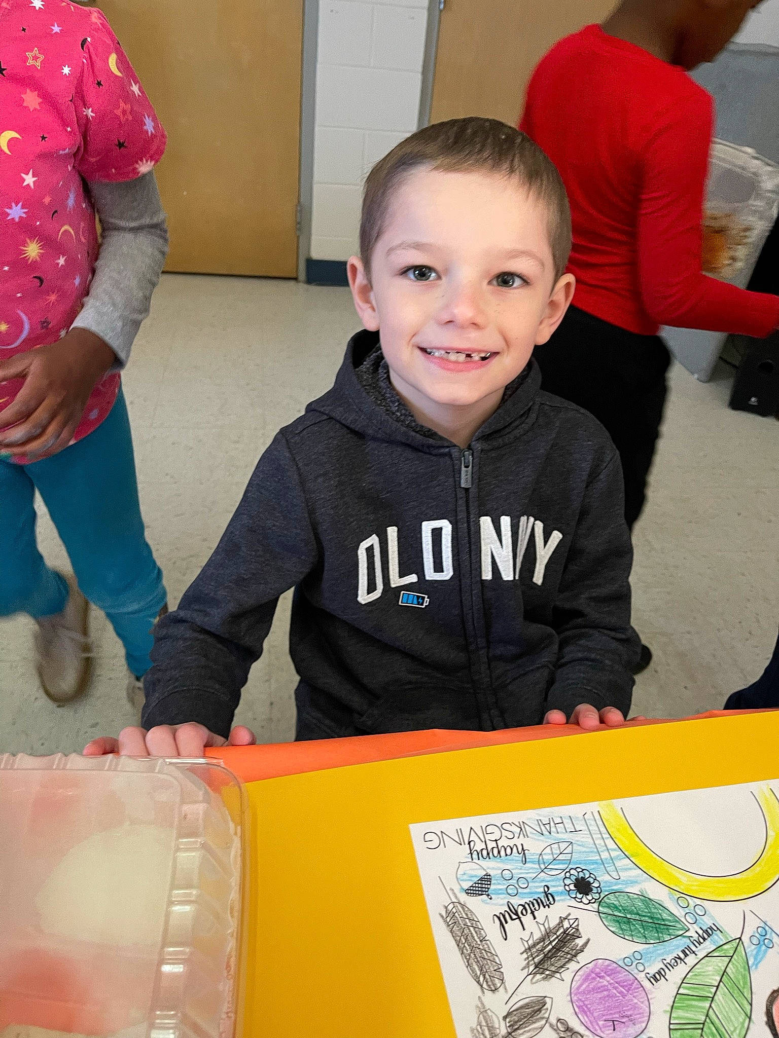 Lawrence is registered to the contest to win money with this photo: art, chair, child, community, drawing, event, fun, happy, joy, leisure, person, play, recreation, red, room, sharing, smile, snapshot, t_shirt, table