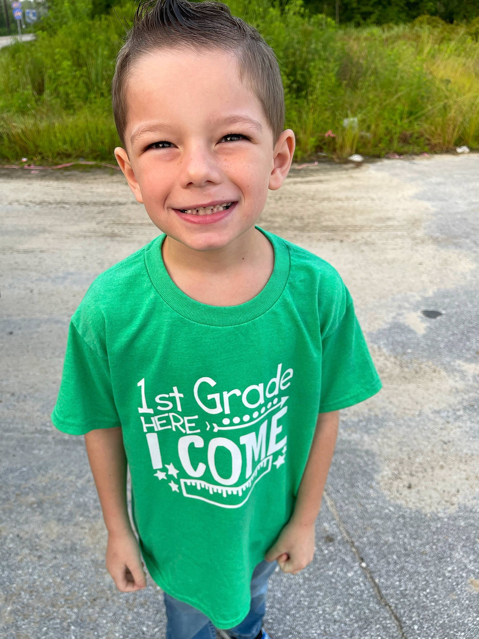 Lawrence is registered to the contest to win money with this photo: active_shirt, asphalt, baby_toddler_clothing, body_of_water, child, electric_blue, fun, grass, hair, happy, head, joy, leisure, neck, person, plant, recreation, sleeve, smile, t_shirt
