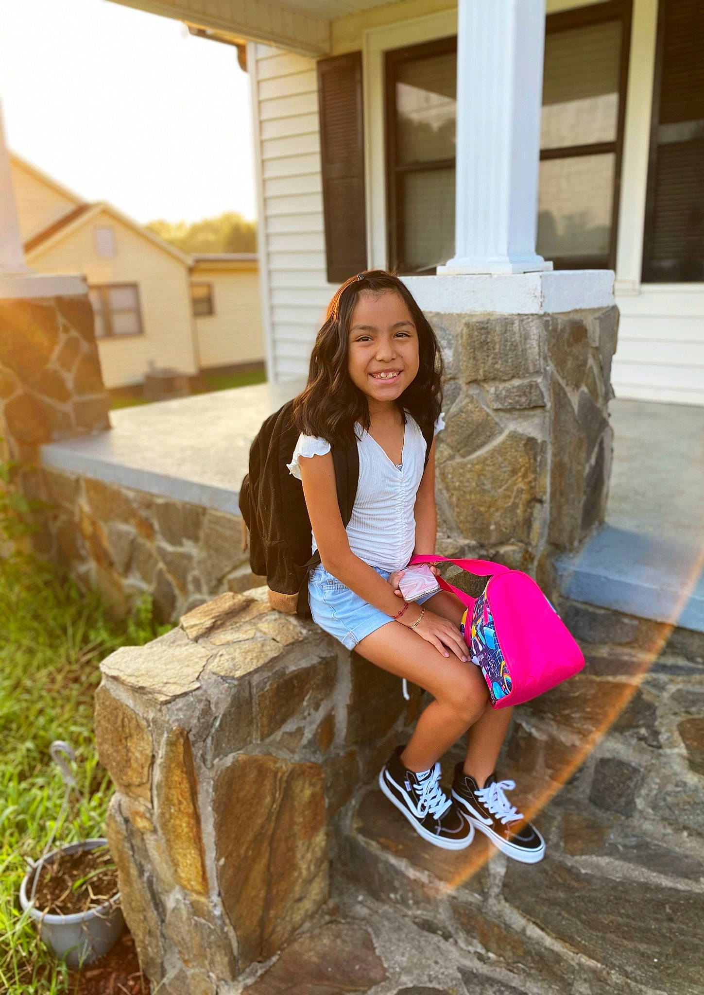 Yasmine is registered to the contest to win money with this photo: building, fawn, flooring, footwear, fun, grass, happy, house, human_leg, joy, landscape, leg, leisure, person, plant, smile, sneakers, summer, thigh, travel