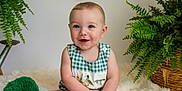 Clayton joined the competition — help win amazing prizes! baby, child, smiling, sitting, plush_toy, duck, greenery, plant, basket, indoor, cute, portrait, happy, checkered_clothing, embroidery, fluffy_rug, infant, blue_eyes, soft_lighting, home_decor