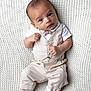 baby, infant, child, vest, bow_tie, pants, socks, knitted_blanket, white_blanket, cute, portrait, lying_down, hands, feet, expression, fashion, soft_texture, indoor, newborn, adorable