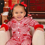 Tierone joined the competition — help win amazing prizes! child, girl, pajamas, red_bows, armchair, christmas_presents, holiday, wreath, smiling, festive, indoor, decorations, winter, snowflakes, cozy, portrait, cute, holiday_season, celebration, happy