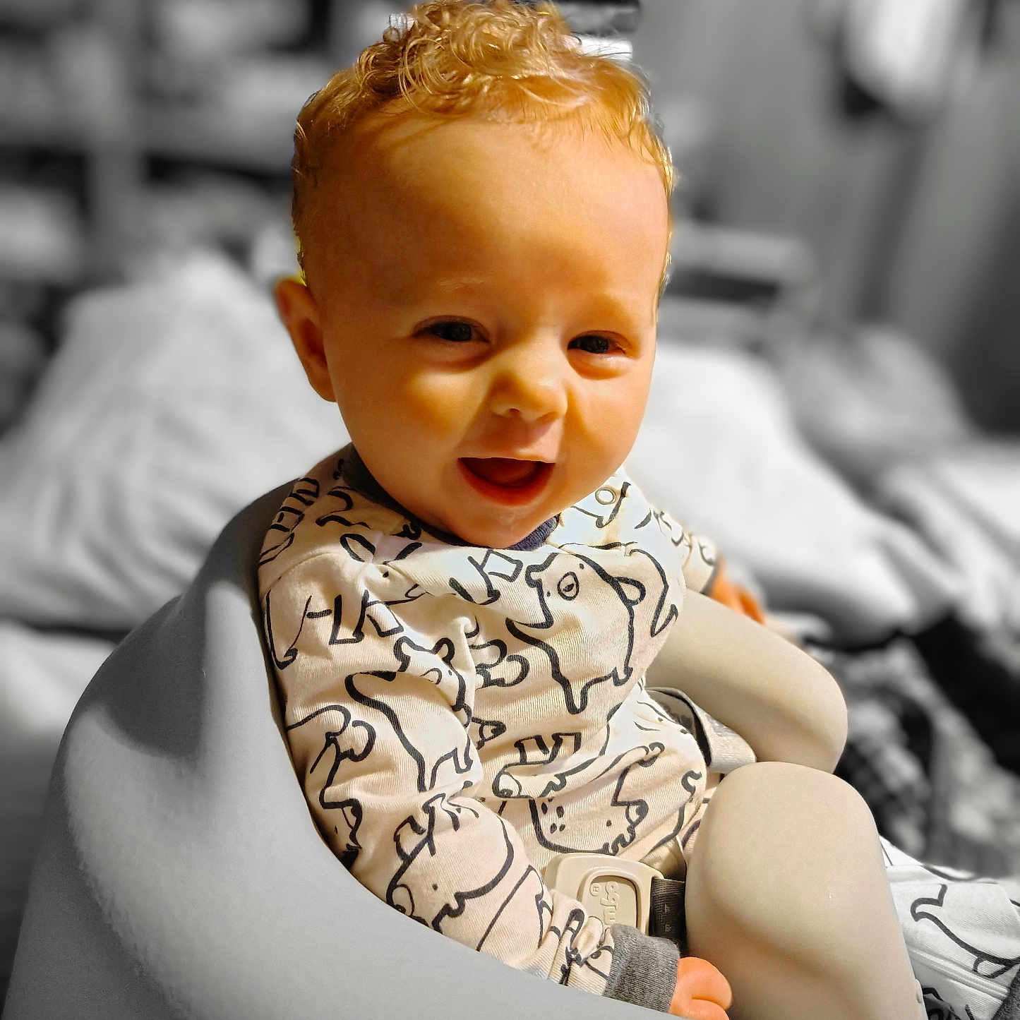 Wilder is registered to the contest to win money with this photo: animal_print, baby, baby_chair, child, clothing, comfortable, curly_hair, cute, face, happy, indoor, infant, pattern, person, portrait, seated, skin, smiling, soft_texture, young