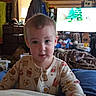 Rowan joined the competition — help win amazing prizes! toddler, child, pajamas, indoor, living_room, television, window, wooden_wall, furniture, curtains, painting, coat, toy, blanket, person, face, smile, home, casual, cozy