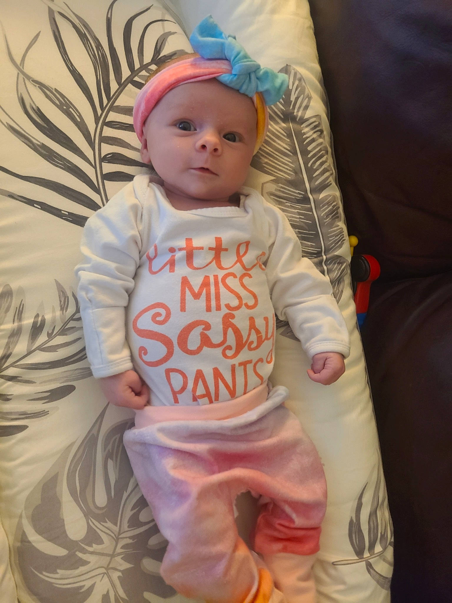 Kendra joined the competition — help win amazing prizes! baby, baby_products, baby_toddler_clothing, cheek, child, eye, head, headgear, headwear, human_body, linens, magenta, pattern, peach, person, pink, sitting, skin, sleeve, t_shirt