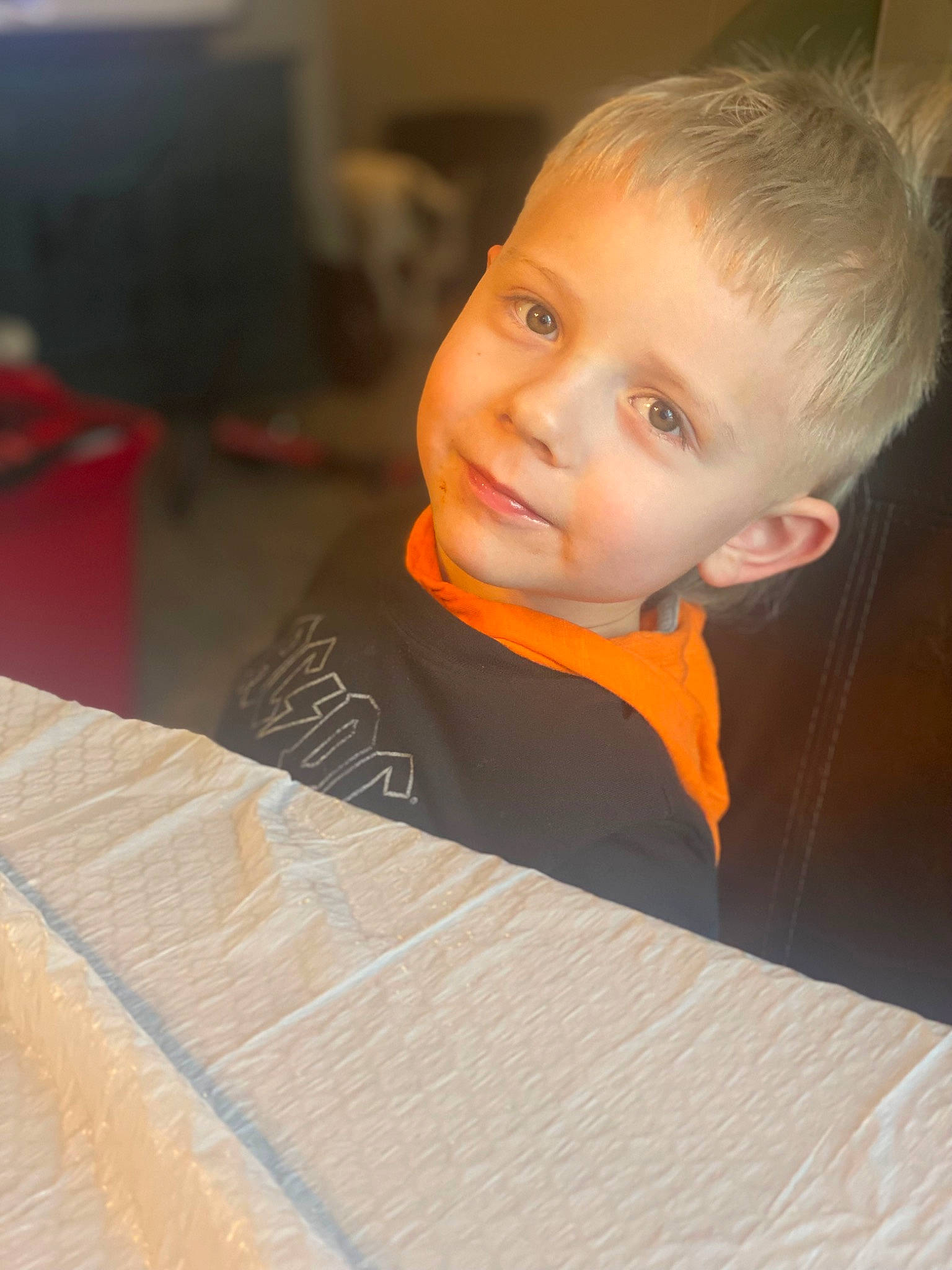 Winston joined the competition — help win amazing prizes! cheek, child, flash_photography, flooring, fun, happy, hardwood, head, human_body, iris, linens, nose, orange, person, room, sitting, t_shirt, toddler, varnish, wood