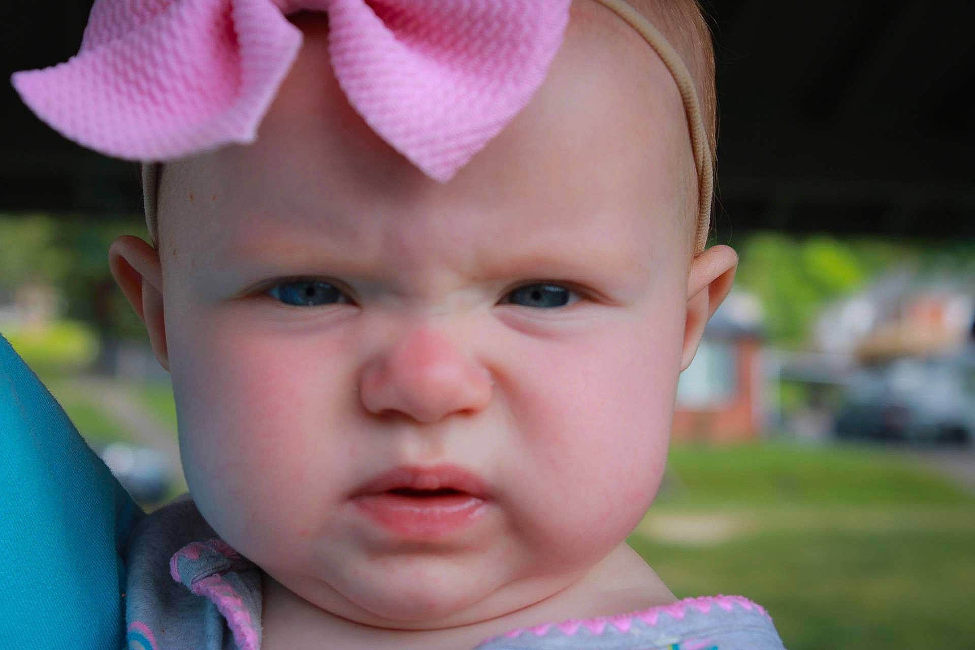 Savannah is registered to the contest to win money with this photo: baby, cheek, chin, ear, eye, eyebrow, eyelash, face, facial_expression, finger, grass, happy, headwear, iris, lip, mouth, nose, person, pink, skin