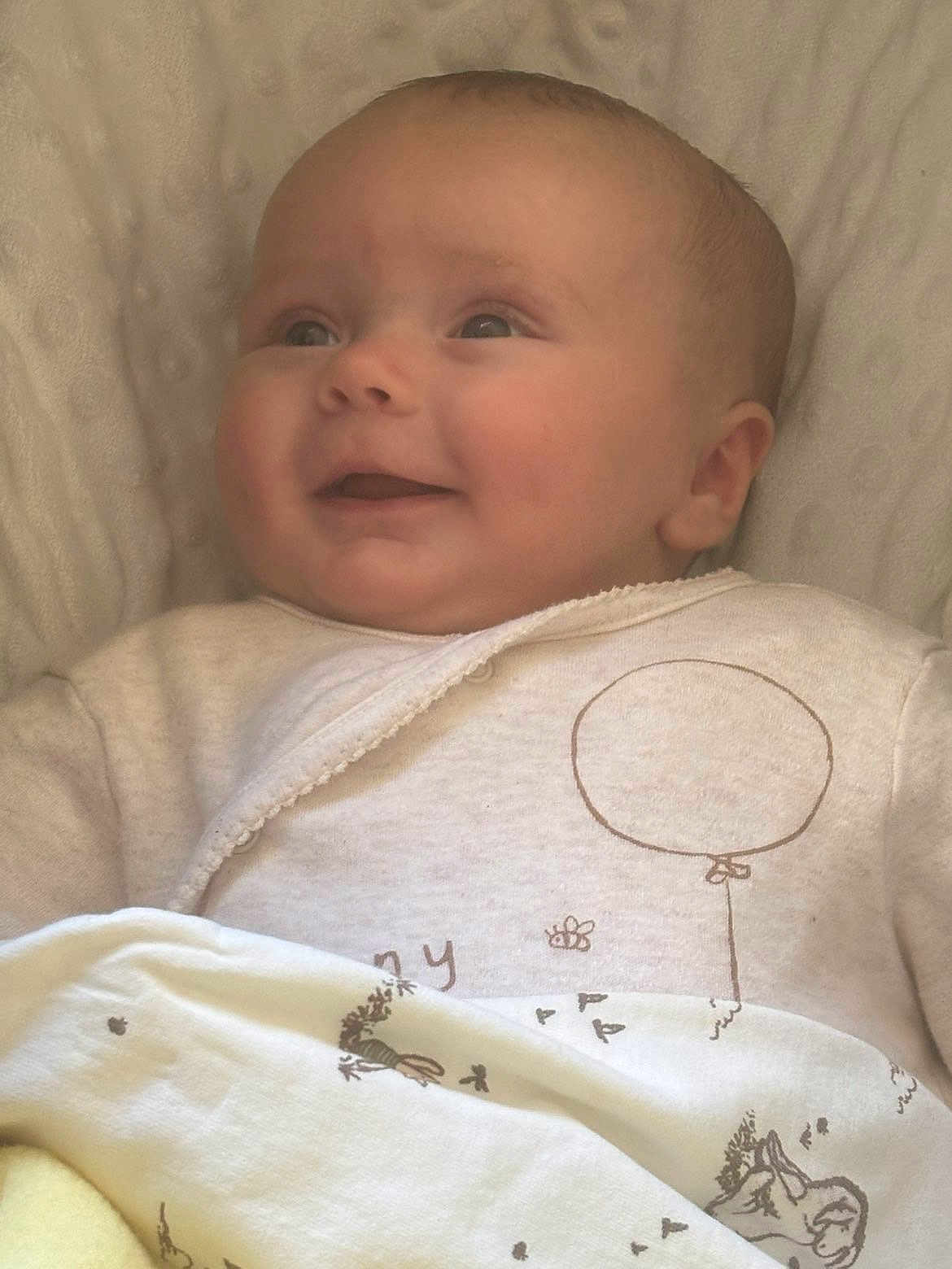 Sylvia joined the competition — help win amazing prizes! baby, infant, smiling, blanket, clothing, face, portrait, cute, child, happy, bed, soft, cozy, newborn, lying_down, wrapped, warm, head, eyes, expression