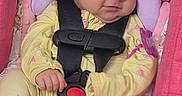 Maylynn is registered to the contest to win money with this photo: baby, infant, child, sleepy, face, portrait, car_seat, seatbelt, buckle, pacifier, yellow_outfit, pink, purple, cozy, sitting, indoors, closeup, baby_clothing, cushion, photography