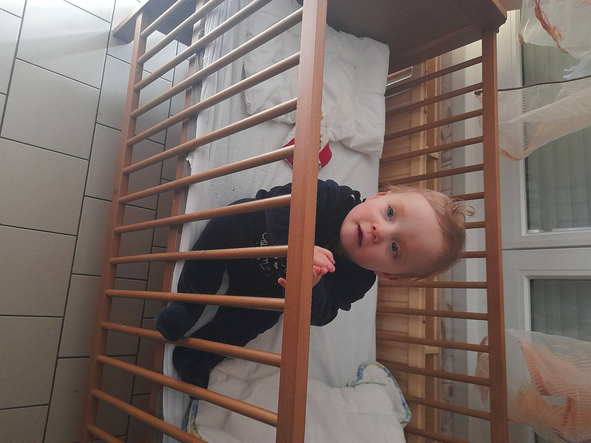 Kenzo participe au concours pour gagner de l'argent avec cette photo : baby_products, building, ceiling, daylighting, door, dress, flooring, handrail, hardwood, house, line, metal, person, porch, room, stairs, toddler, tree, window, wood