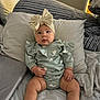 baby, bed, bodypart, bonnet, boy, child, clothing, couch, cushion, diaper, face, finger, furniture, hat, head, homedecor, hosiery, male, person, sock