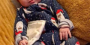 Echo is registered to the contest to win money with this photo: baby, blanket, child, cloth, comfort, cozy, cute, expression, face, festive, hand, holiday, indoors, infant, lying_down, onesie, pillow, resting, santa_claus, soft