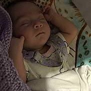 Echo joined the competition — help win amazing prizes! baby, blanket, closeup, clothing, comfort, cozy, cute, face, hands, indoors, infant, knit, patterned_background, peaceful, portrait, purple, resting, sleeping, soft_lighting, toddler