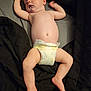 baby, sleeping, diaper, infant, peaceful, drool, arms_up, legs_spread, black_quilt, soft_lighting, skin, relaxed, cute, naptime, indoors, child, newborn, portrait, resting, barefoot