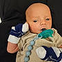 Sylus joined the competition — help win amazing prizes! baby, infant, pacifier, mittens, striped_clothing, person, newborn, cute, face, head, hand, beads, pacifier_clip, lying_down, closeup, skin, expression, indoors, young_child, resting