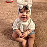baby, child, smiling, headband, bow, white_shirt, denim_shorts, carpet, indoor, cute, happy, sitting, infant, person, skin, face, hands, toes, playful, young
